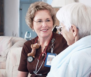 Nurse supports patient in her home.