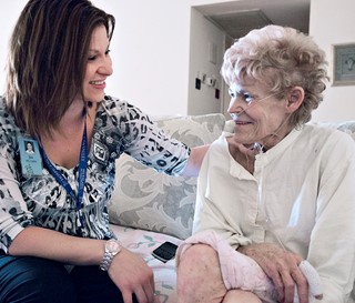 Nurse comforting female patient